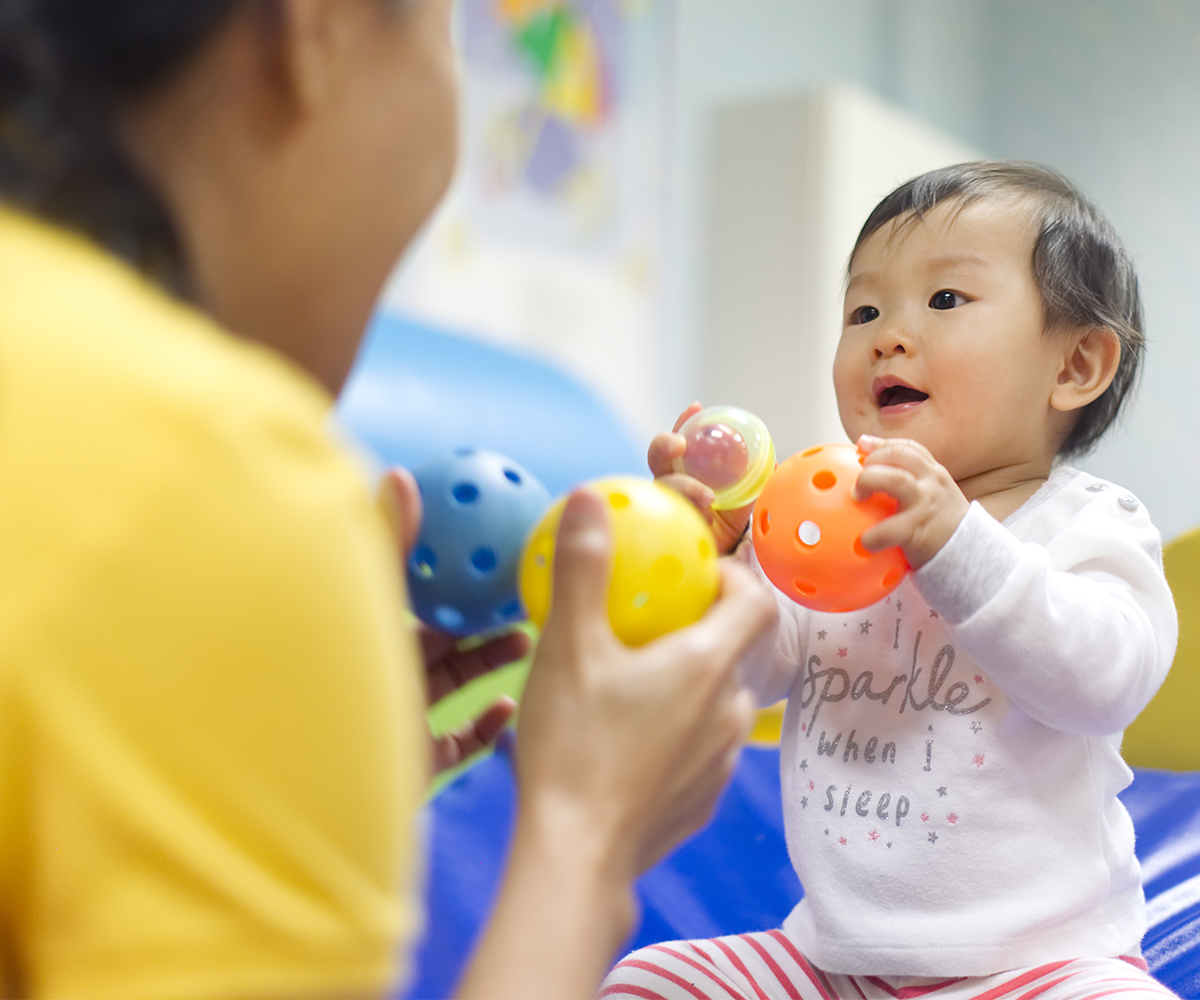 1200x1000_Asian toddler with toy balls