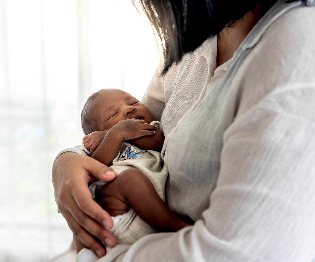 1200x1000_newborn baby in caretaker arms